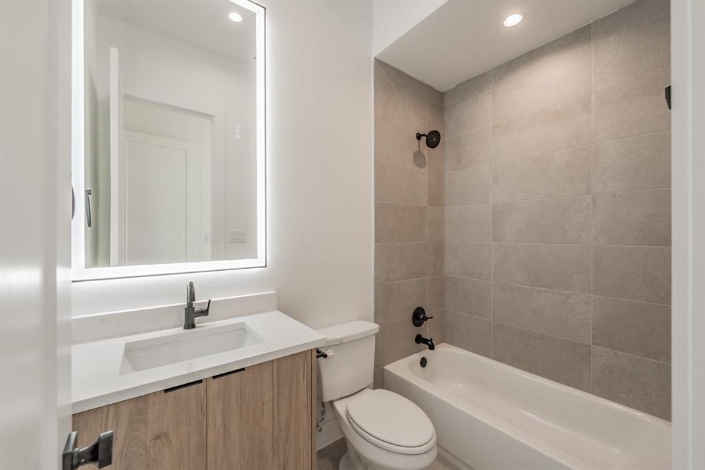 5320 Reiger Avenue, Unit 103 Dallas, TX 75214 - Photo 22 of 29 a bathroom with a sink a toilet and shower