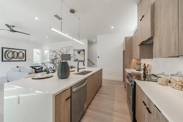 a kitchen with sink a stove and cabinets