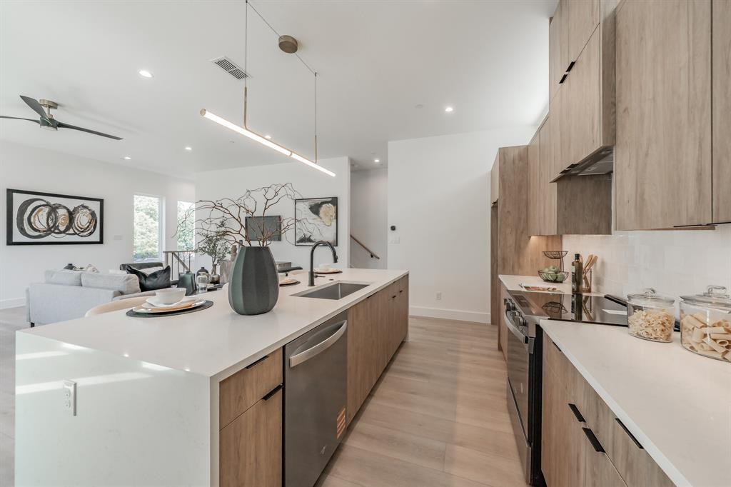 5320 Reiger Avenue, Unit 103 Dallas, TX 75214 - Photo 8 of 29 a kitchen with sink a stove and cabinets