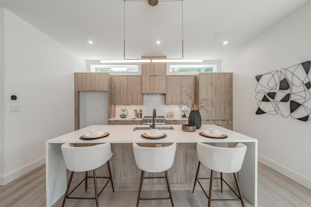 5320 Reiger Avenue, Unit 103 Dallas, TX 75214 - Photo 9 of 29 a view of a dining room with furniture and wooden floor
