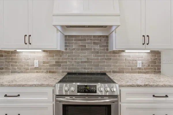 a stove top oven sitting inside of a kitchen