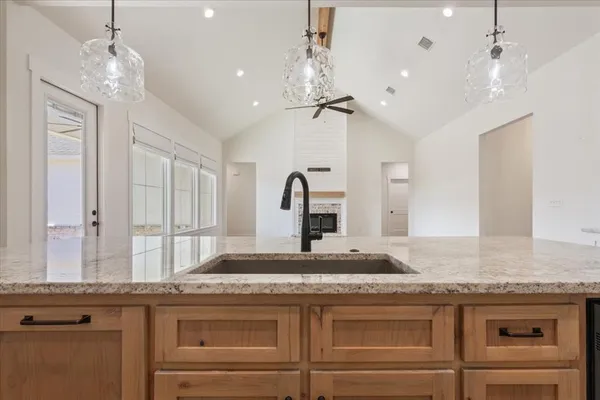 a kitchen with cabinets a sink and appliances