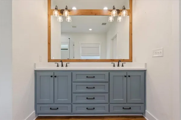 a bathroom with a sink vanity and mirror