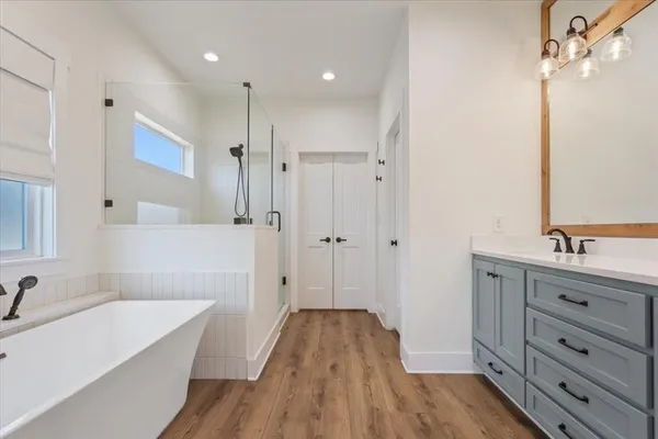 a bathroom with a sink a bathtub and a shower