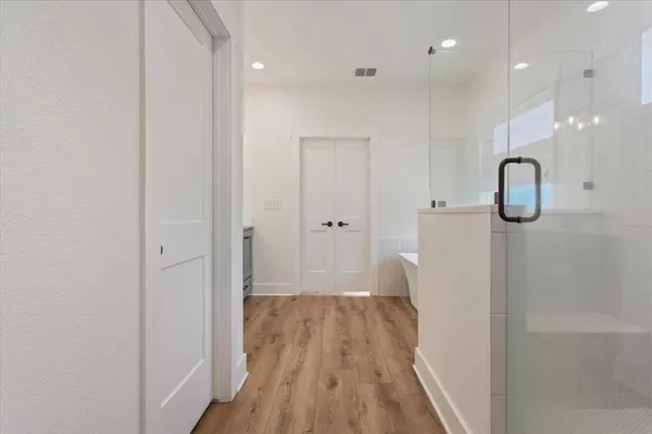 a view of hallway with wooden floor