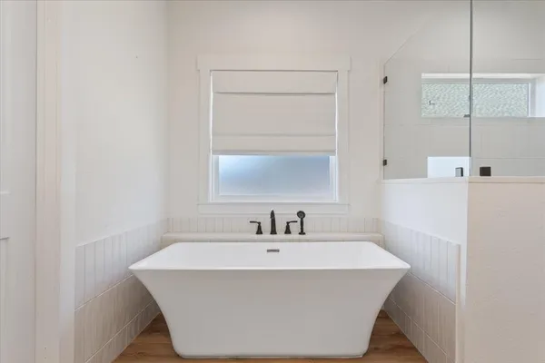 a white bath tub sitting in a bathroom