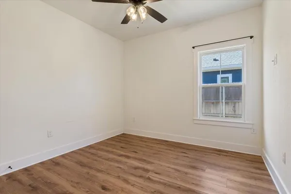 wooden floor in an empty room with a window