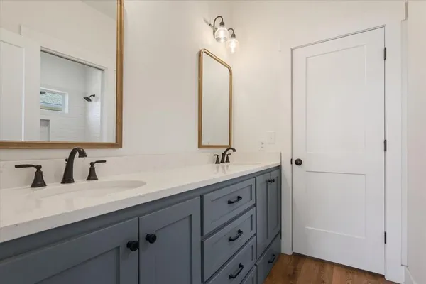 a bathroom with a double vanity sink and a mirror