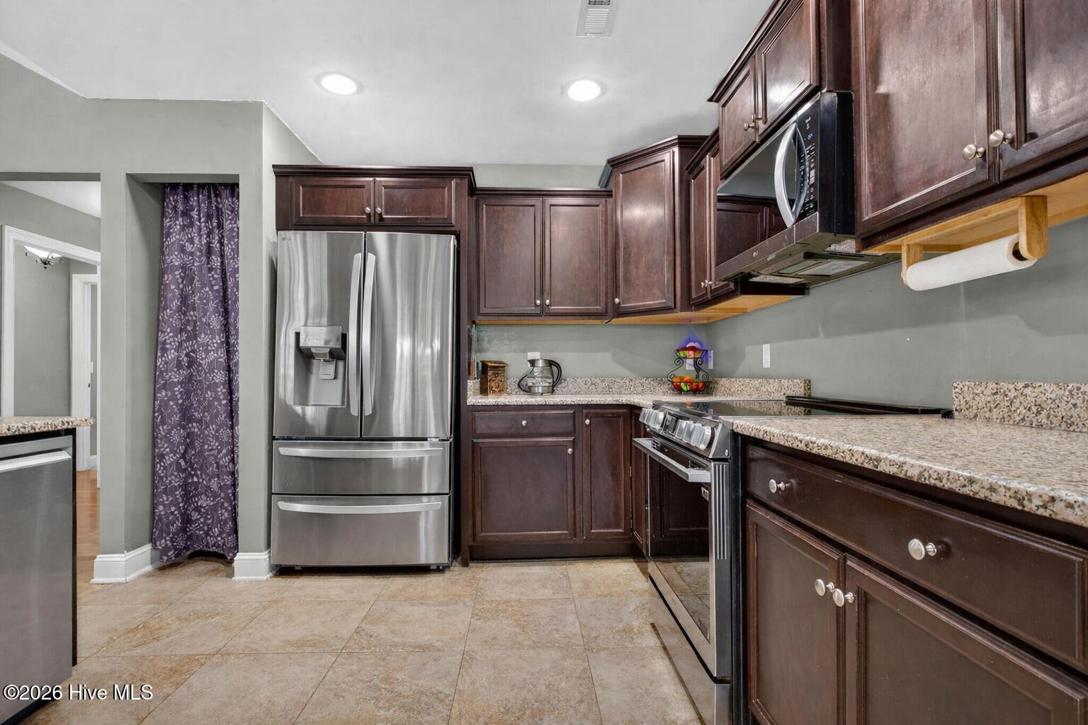 2020 Albemarle Road Southport, NC 28461 - Photo 12 of 61 Modern kitchen with cherry wood cabinetr