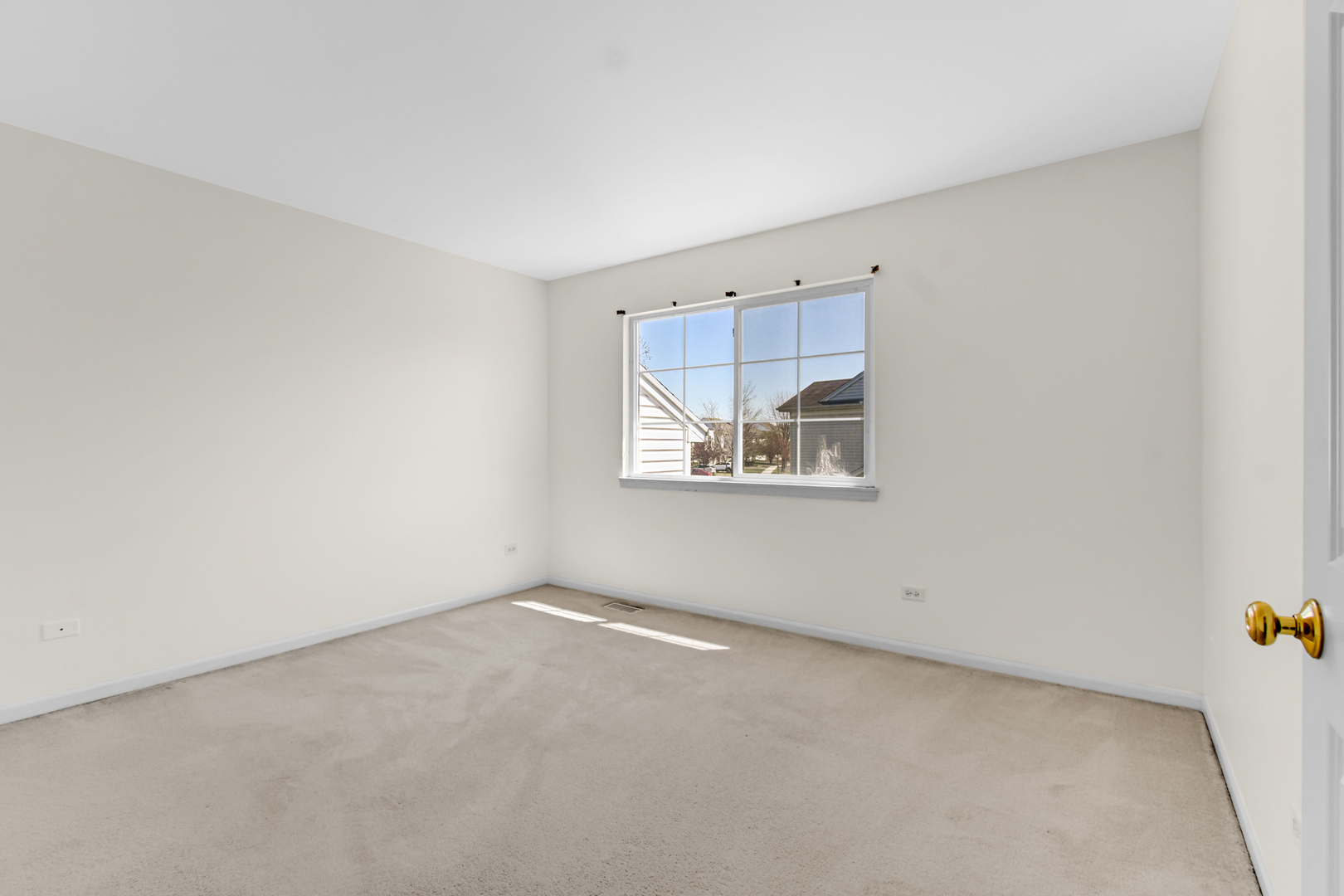 16743 Winding Creek Road Plainfield, IL 60586 - Photo 14 of 25 an empty room with windows