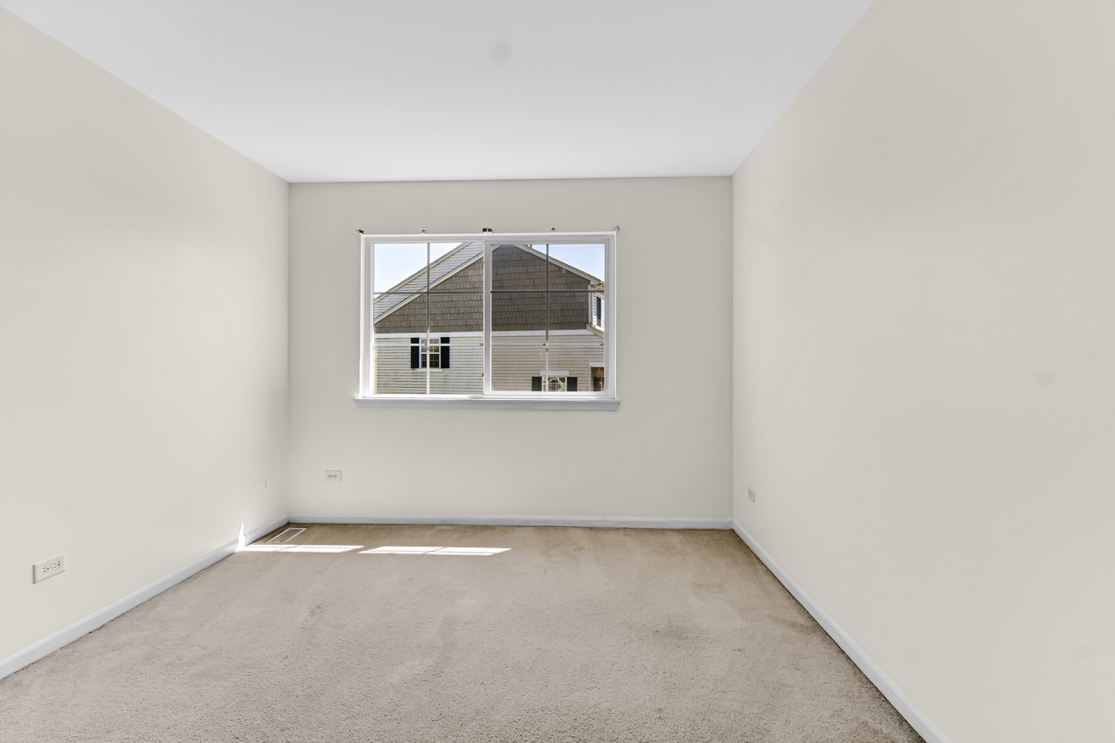 16743 Winding Creek Road Plainfield, IL 60586 - Photo 16 of 25 an empty room with a window