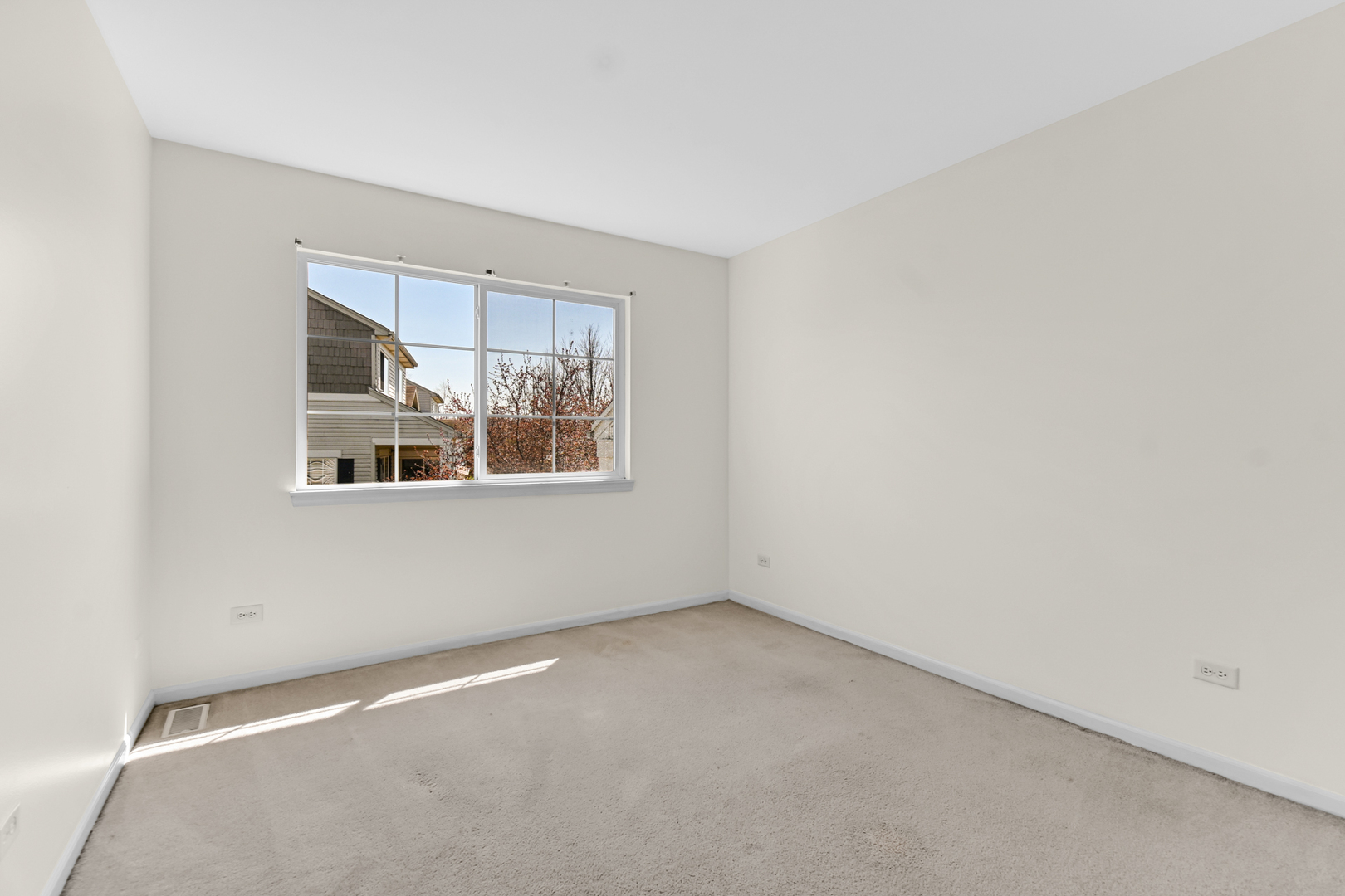 16743 Winding Creek Road Plainfield, IL 60586 - Photo 19 of 25 an empty room with a window