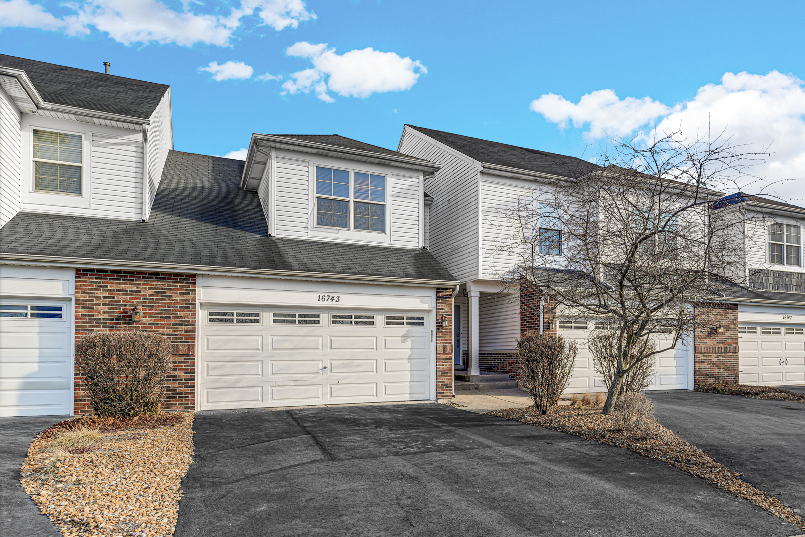 16743 Winding Creek Road Plainfield, IL 60586 - Photo 2 of 25 a front view of a house with a yard and garage