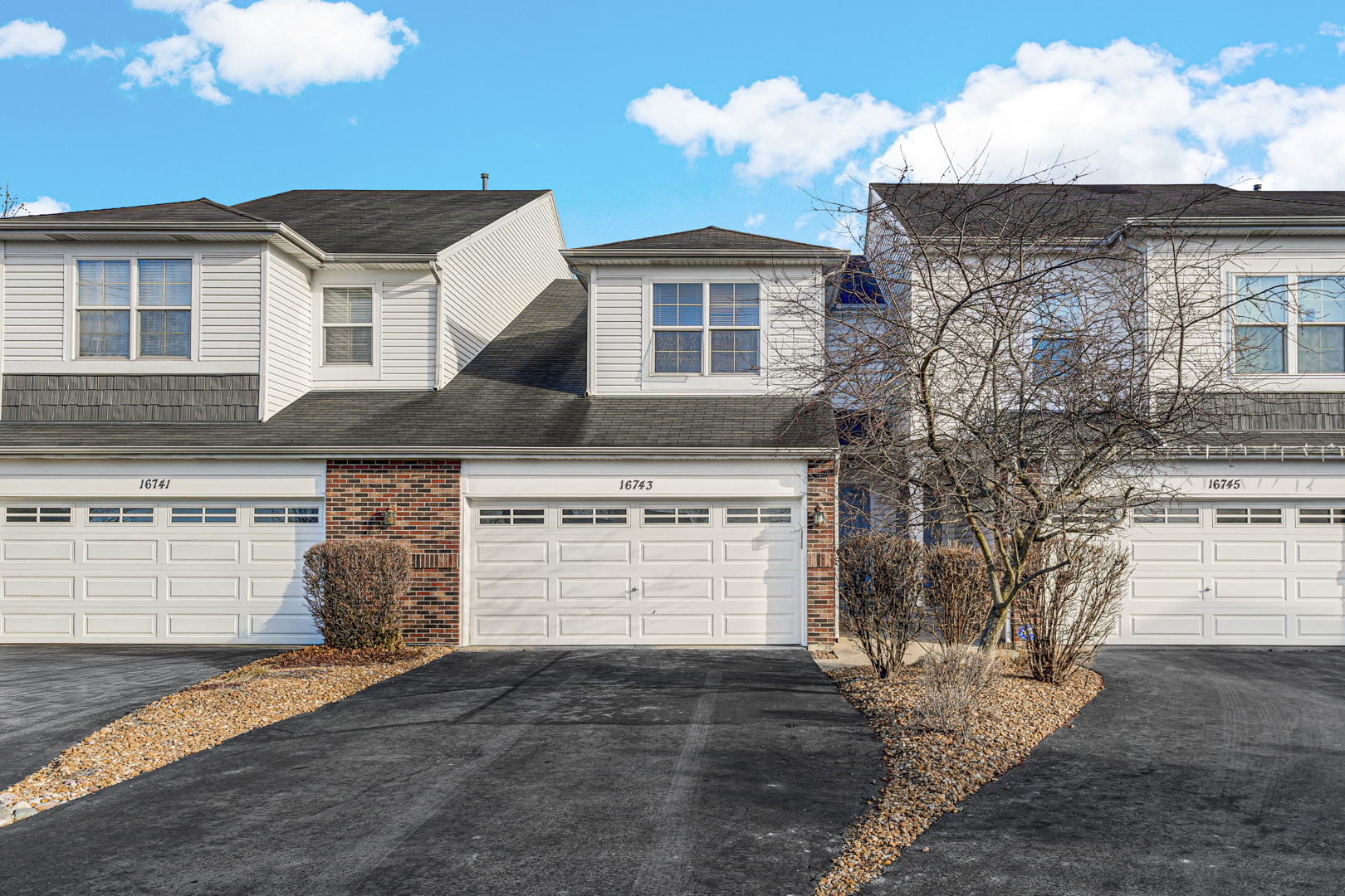 16743 Winding Creek Road Plainfield, IL 60586 - Photo 4 of 25 a front view of a house with a yard and garage