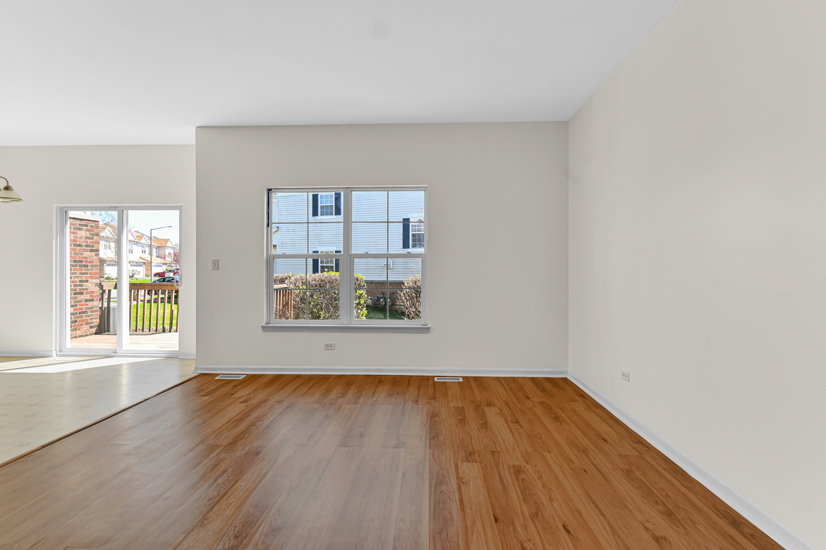 16743 Winding Creek Road Plainfield, IL 60586 - Photo 9 of 25 an empty room with wooden floor and a window