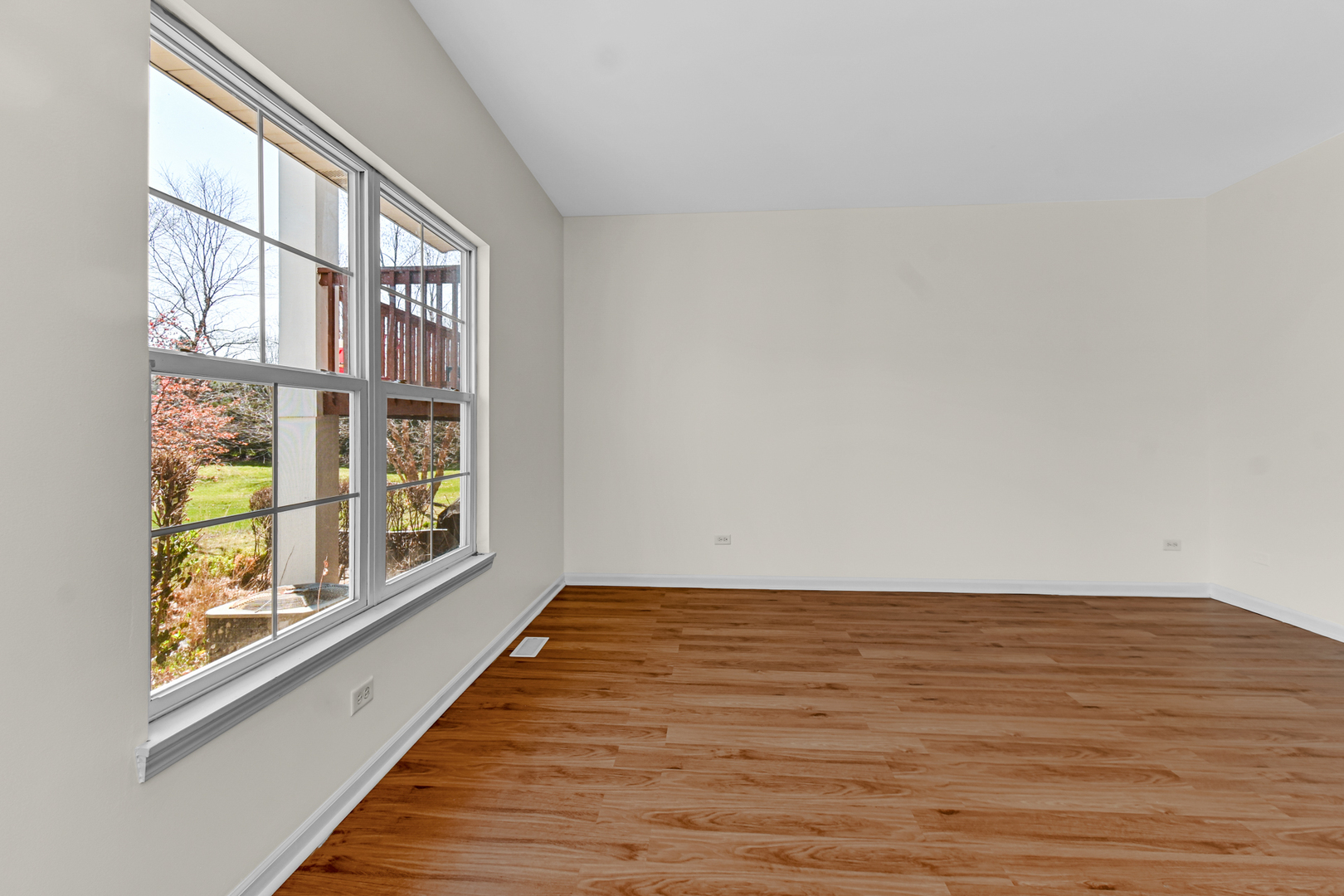 16743 Winding Creek Road Plainfield, IL 60586 - Photo 10 of 25 a view of an empty room with wooden floor and a window