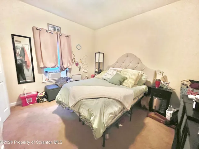 a bedroom with a bed and a table