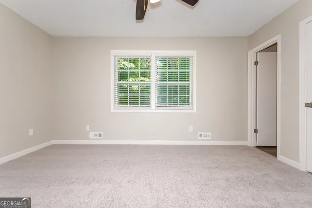 an empty room with a empty space and windows