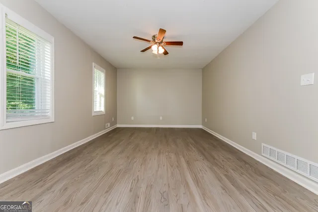 wooden floor in an empty room with a window