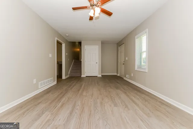 wooden floor in an empty room with a window