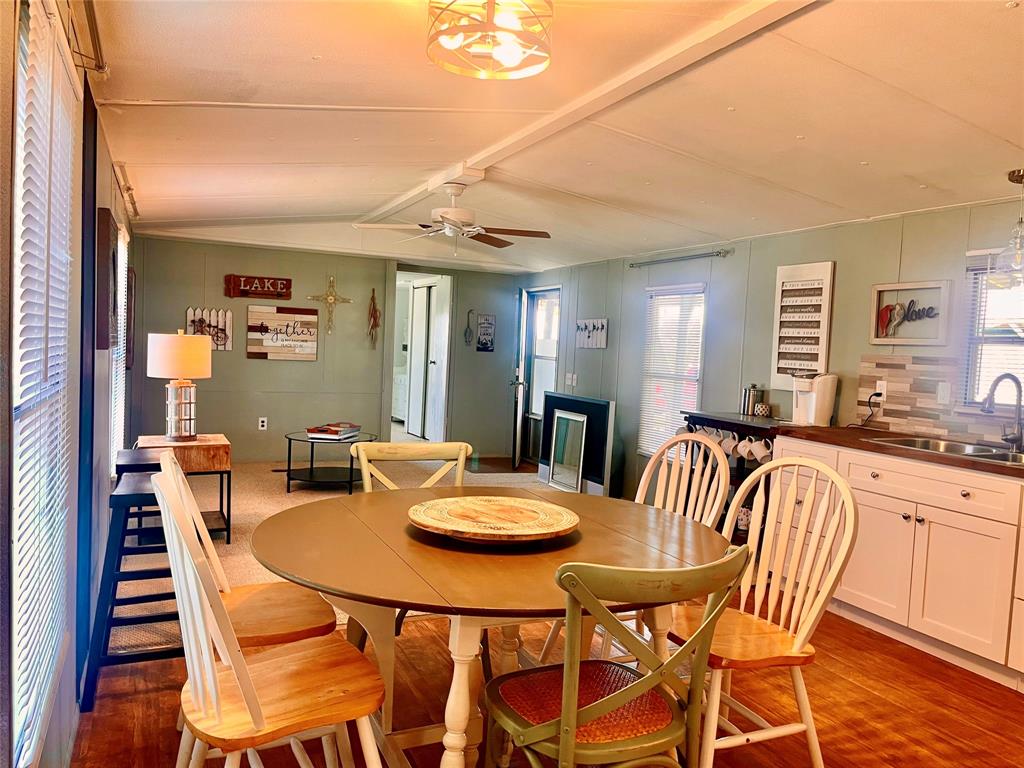 2334 San Bar Road, Unit 96 Graford, TX 76449 - Photo 11 of 40 Room for a full dining table and some elbow room is always a nice feature. The slightly vaulted ceiling makes this space feel even larger, and the plentiful windows allow natural light indoors.