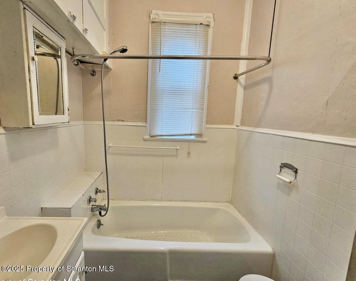 1531 Washburn Street, Unit 1 Scranton, PA 18504 - Photo 4 of 6 a bathroom with a tub a sink and a shower