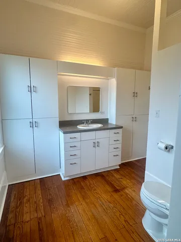 a view of a kitchen cabinets and wooden floor