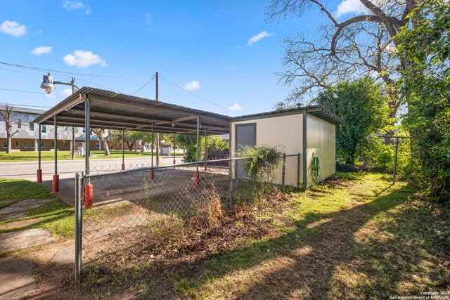 a view of a house with backyard and sitting area