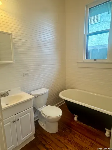 a bathroom with a toilet a sink and a bathtub