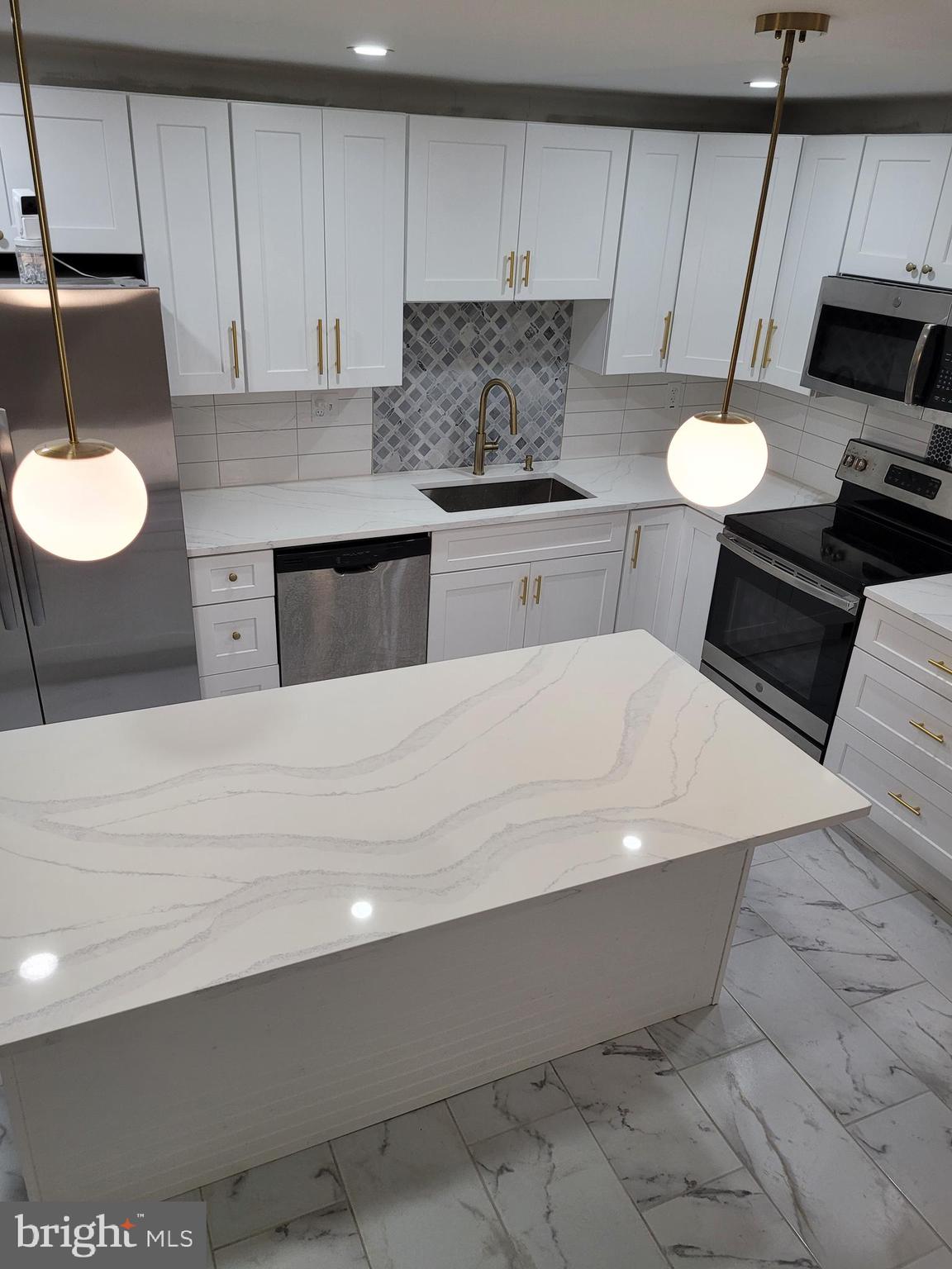 2502 Federal Street Philadelphia, PA 19146 - Photo 18 of 31 a kitchen with a sink dishwasher and a stove
