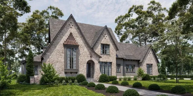 a front view of a house with a yard and potted plants