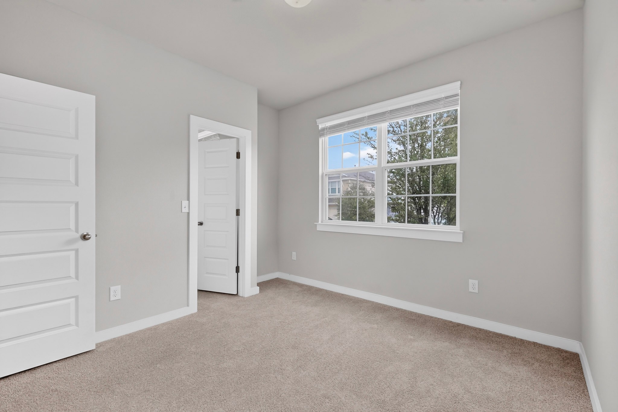 116 Appleberry Lane Elgin, TX 78621 - Photo 26 of 35 A well-lit bedroom with ample space for personalization and a clear view of the neighborhood through a large window.