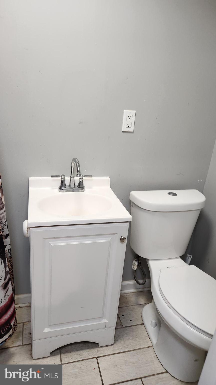 1024 Wicklow Road Baltimore, MD 21229 - Photo 43 of 44 a white toilet sitting next to a bathroom sink