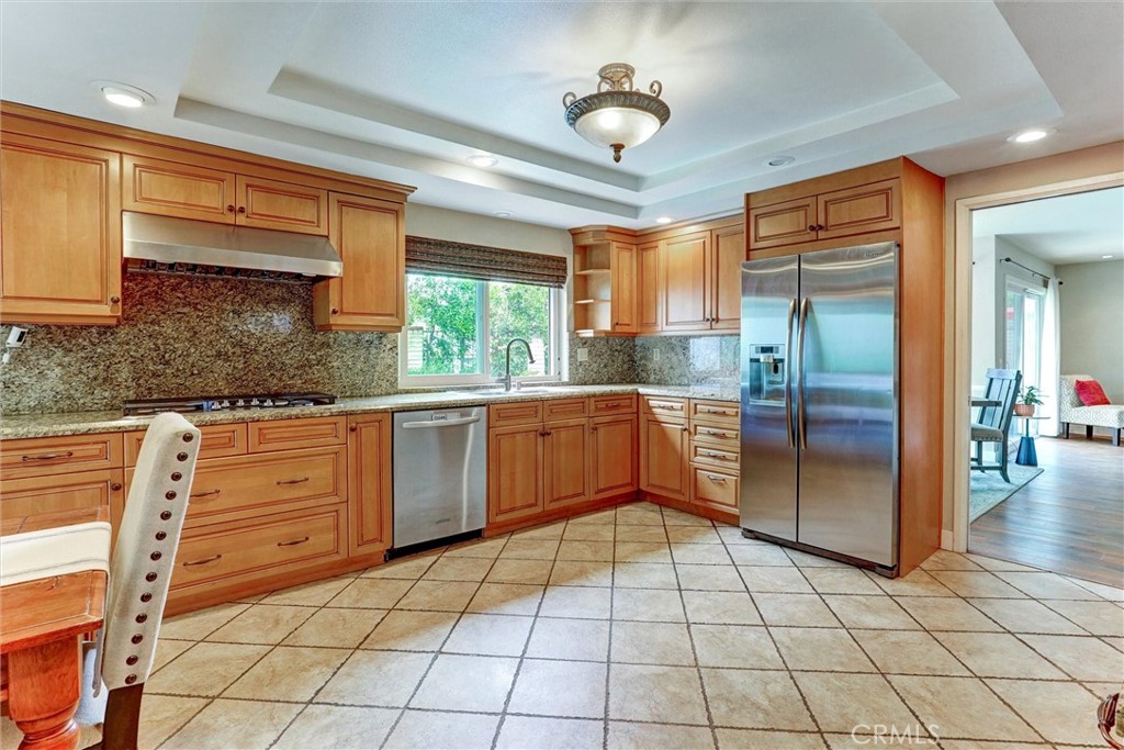 19238 Castlebay Lane Porter Ranch, CA 91326 - Photo 11 of 38 a kitchen with stainless steel appliances granite countertop a stove a sink and a refrigerator