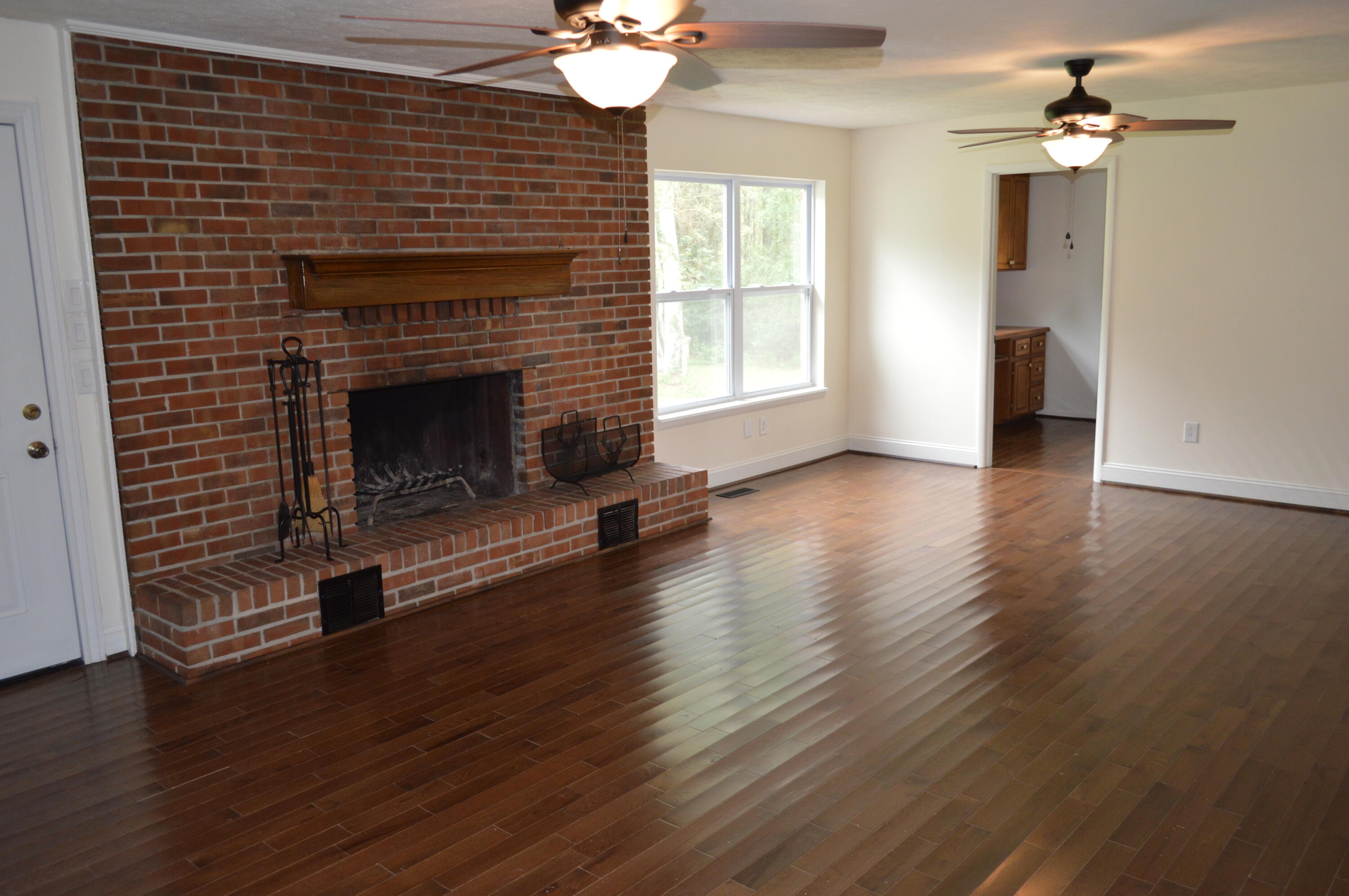 7582 Goat Hill Road See Remarks, AL 36477 - Photo 18 of 43 a living room with wooden floor and a fireplace