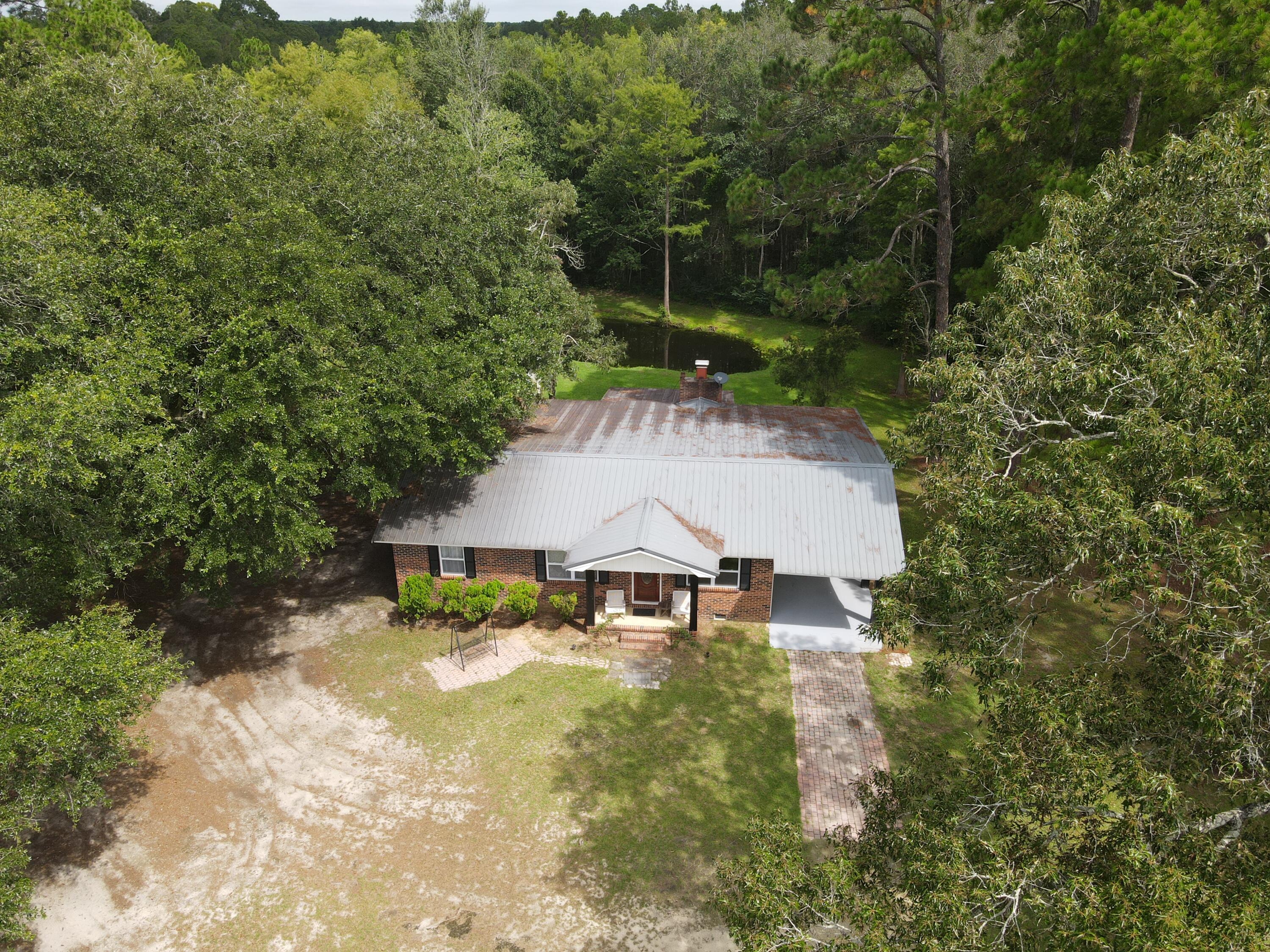 7582 Goat Hill Road See Remarks, AL 36477 - Photo 36 of 43 a view of a house with a yard and sitting area