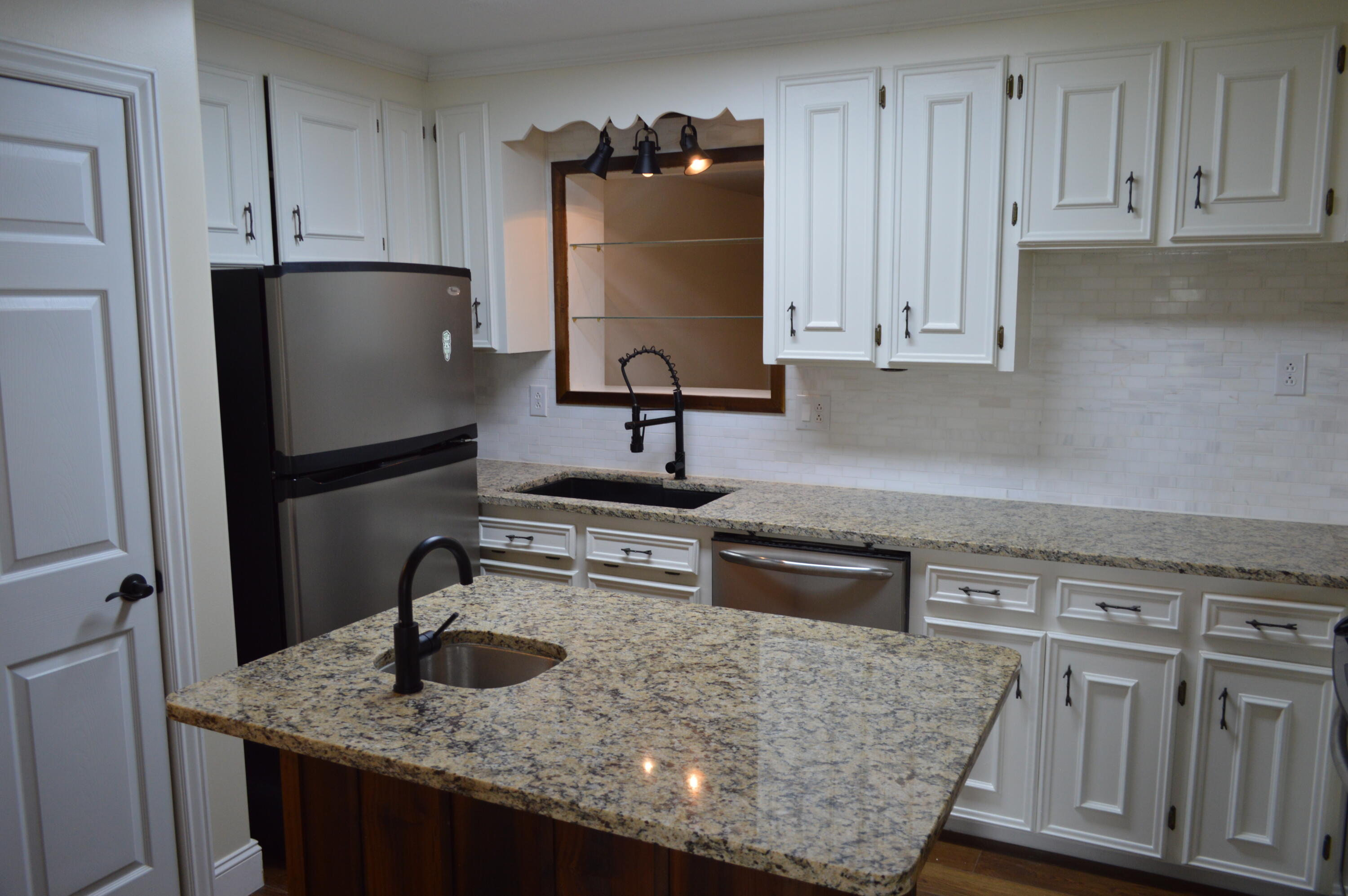 7582 Goat Hill Road See Remarks, AL 36477 - Photo 7 of 43 a kitchen with granite countertop a sink stainless steel appliances and cabinets