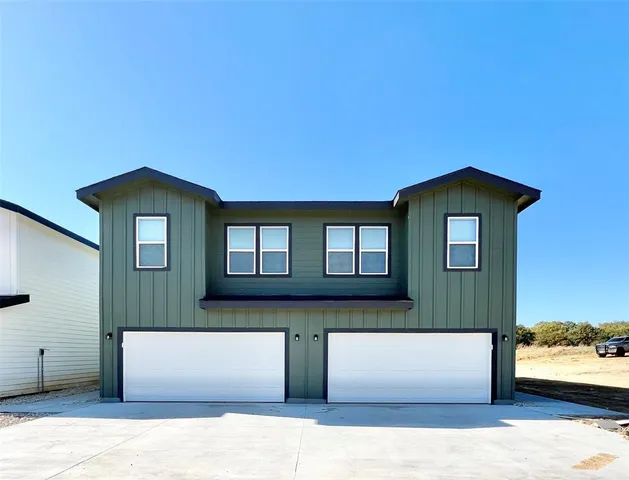 a front view of a house with a garage