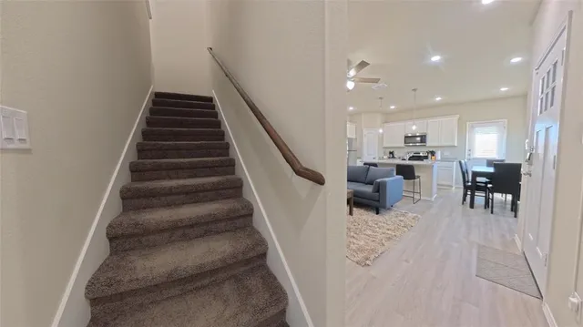 a bedroom with a large bed chandelier and a window