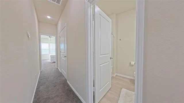 a spacious bedroom with a bed and a chandelier