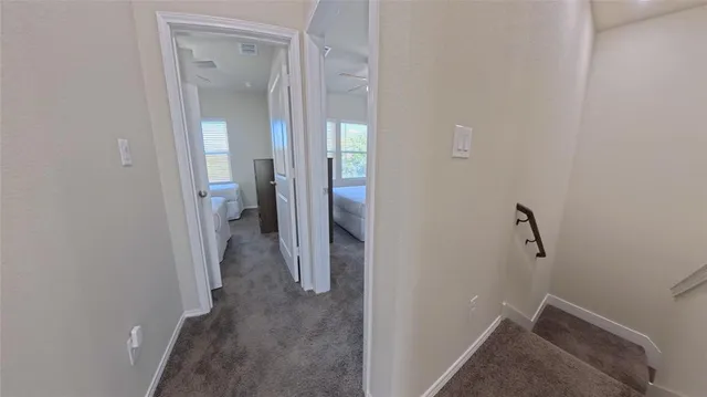 a bedroom with two beds and a chandelier