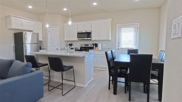 a kitchen with stainless steel appliances granite countertop a stove and a microwave