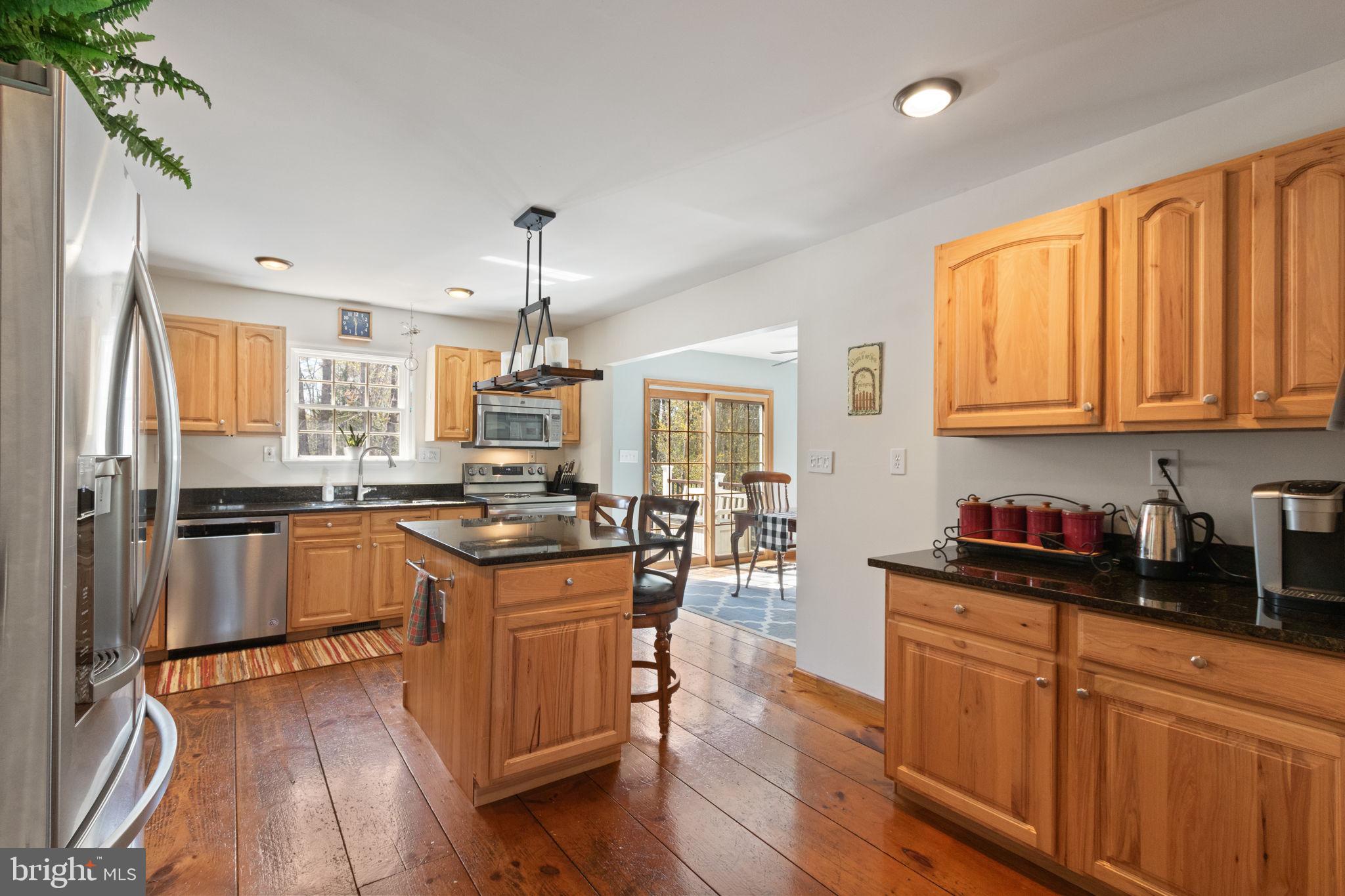 135 Cropp Road Fredericksburg, VA 22406 - Photo 16 of 67 a kitchen with granite countertop wooden floors and stainless steel appliances