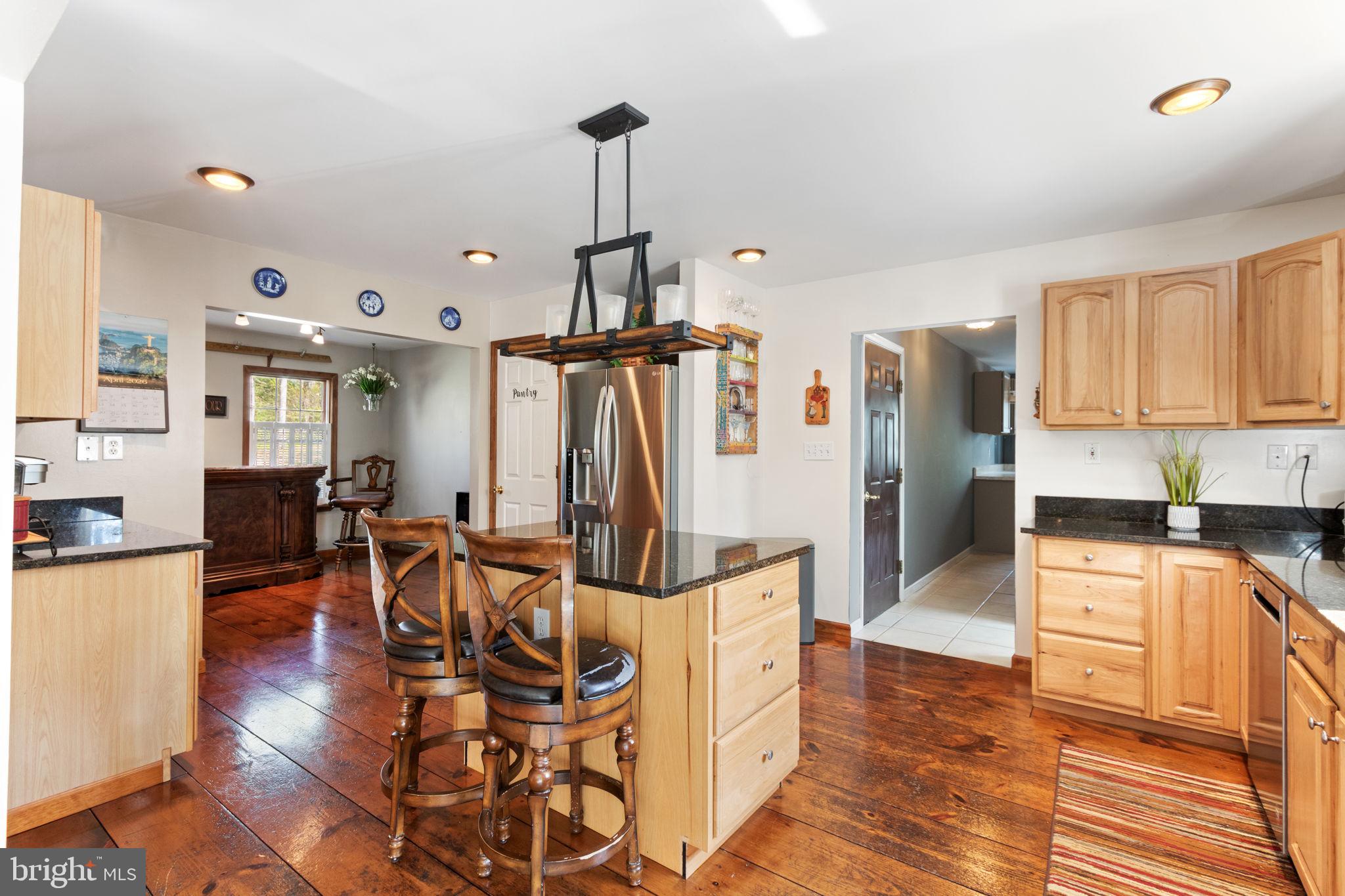 135 Cropp Road Fredericksburg, VA 22406 - Photo 18 of 67 a kitchen with stainless steel appliances granite countertop a refrigerator a stove and a dining table with wooden floor