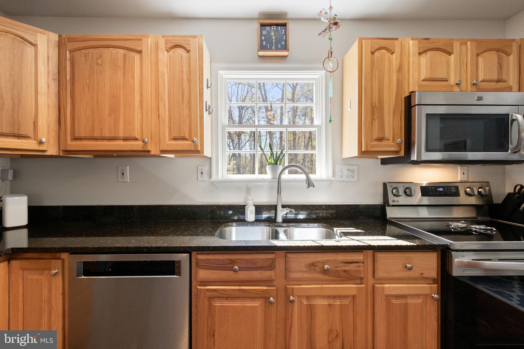 135 Cropp Road Fredericksburg, VA 22406 - Photo 19 of 67 a kitchen with granite countertop a stove a sink and a microwave