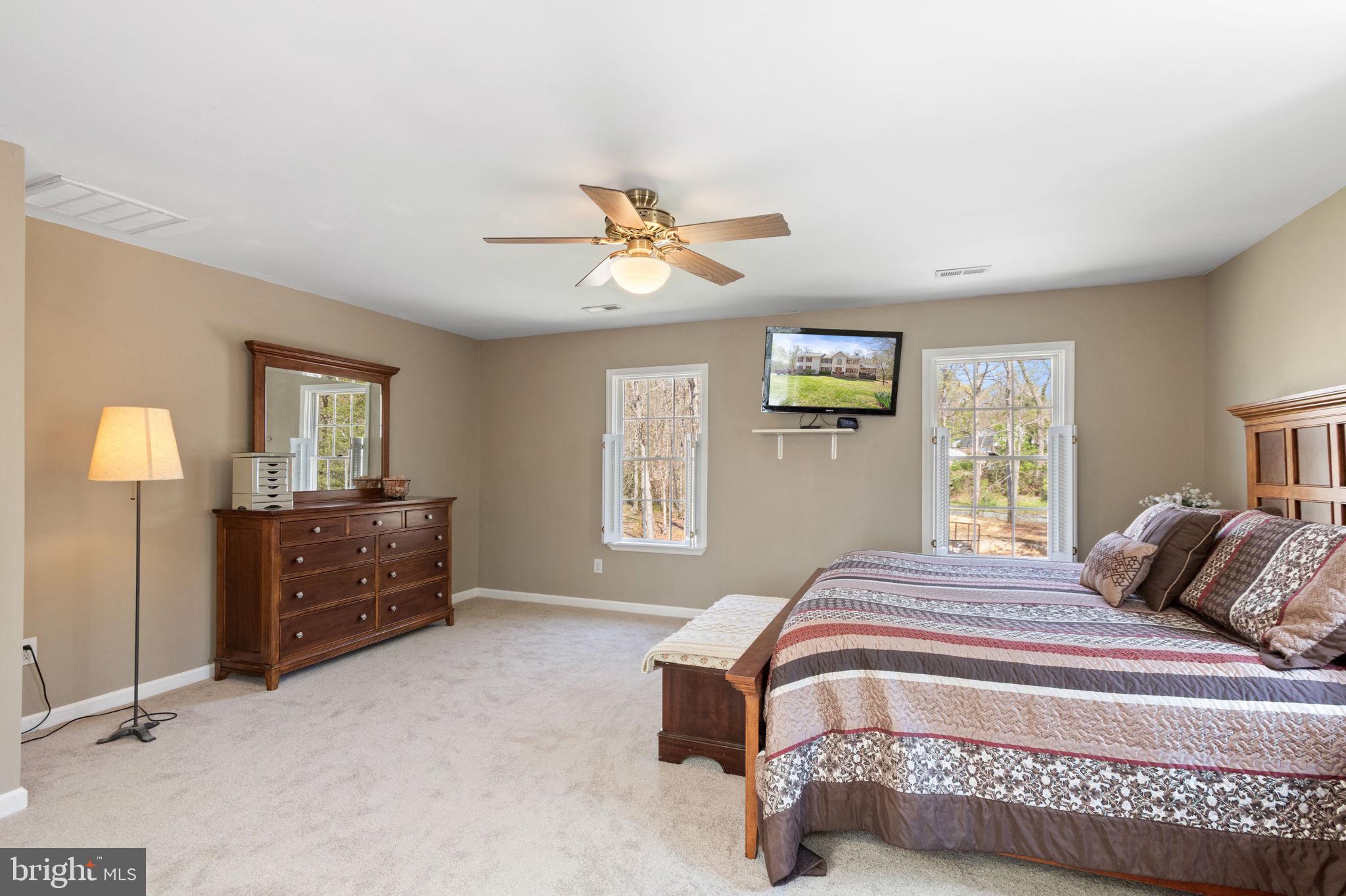 135 Cropp Road Fredericksburg, VA 22406 - Photo 31 of 67 a bedroom with a bed and a chandelier
