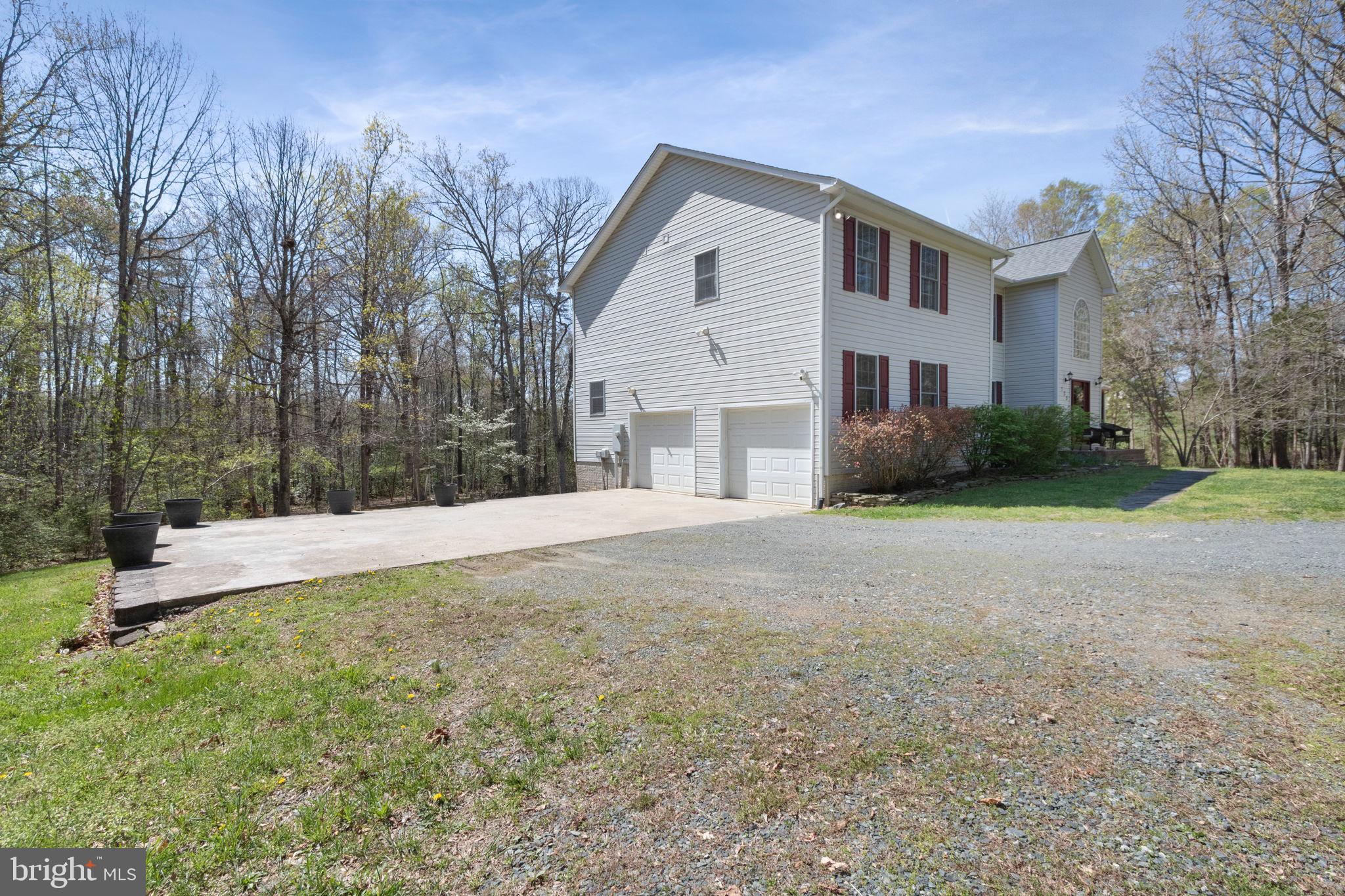 135 Cropp Road Fredericksburg, VA 22406 - Photo 63 of 67 a front view of a house with a yard and garage