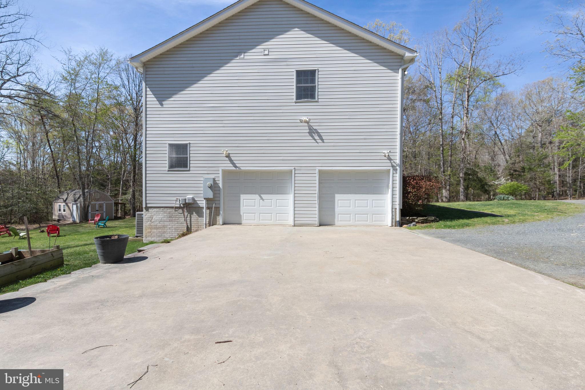 135 Cropp Road Fredericksburg, VA 22406 - Photo 64 of 67 a front view of a house with a yard and garage
