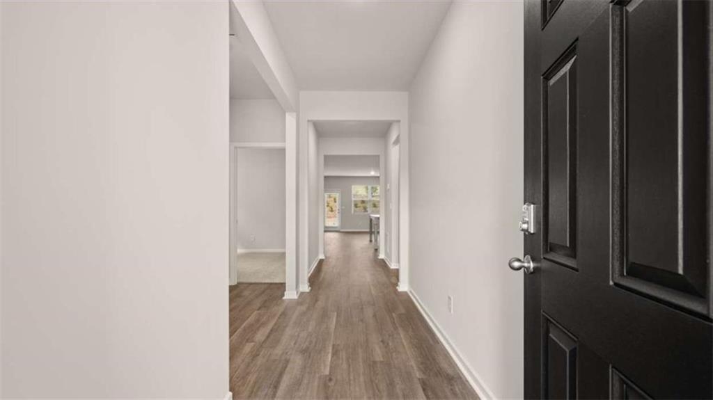 159 Holland Cove Winder, GA 30680 - Photo 2 of 8 a view of a hallway with wooden floor