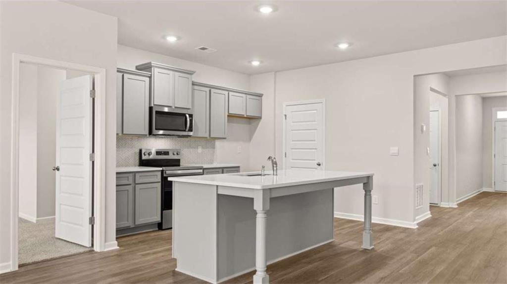 159 Holland Cove Winder, GA 30680 - Photo 6 of 8 a kitchen with appliances cabinets and a sink
